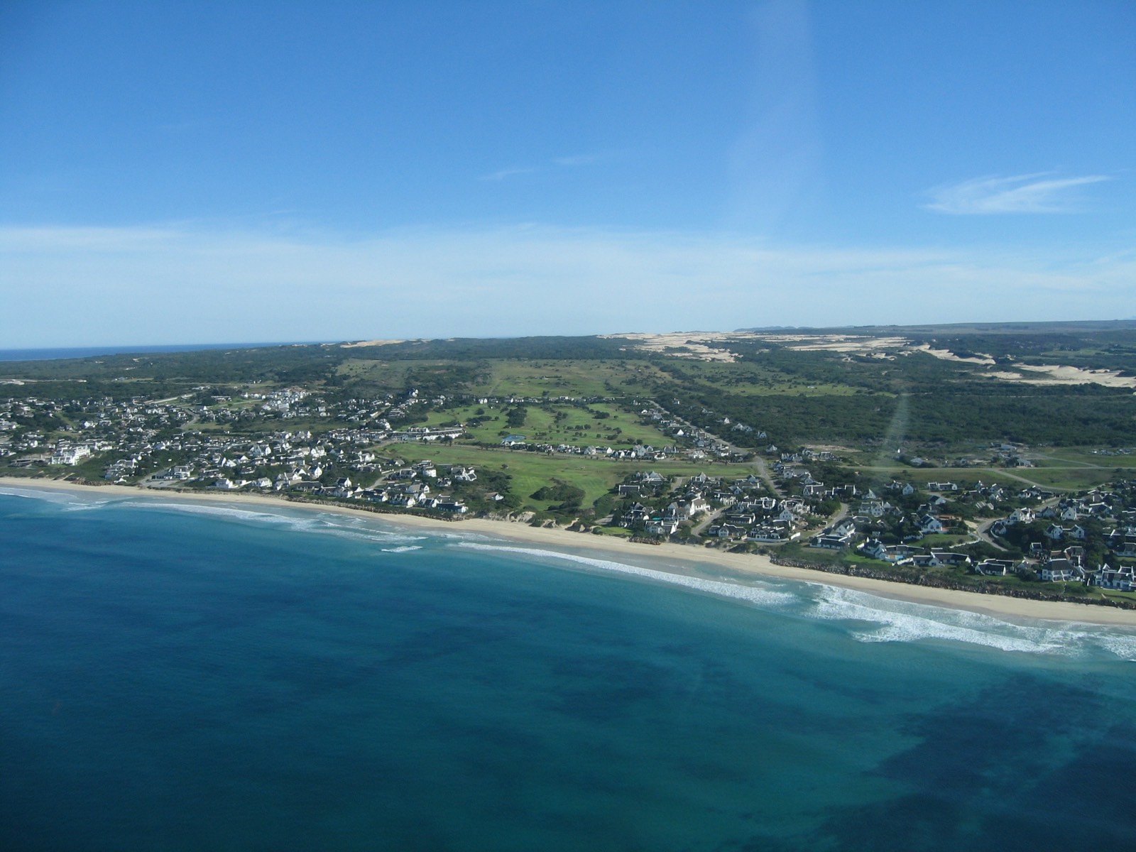 St Francis Bay from the air: the beach, the white-walled village and the golf course